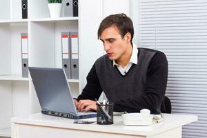 Worried  businessman using laptop photo