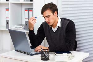 Businessman thinking while working photo