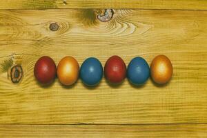 Painted Easter eggs  on wooden table.Toned photo. photo