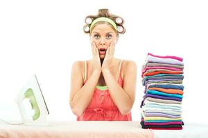 Tired  housewife in panic   ironing photo