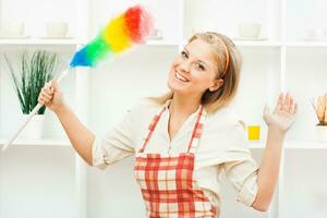 Cheerful housewife cleaning photo