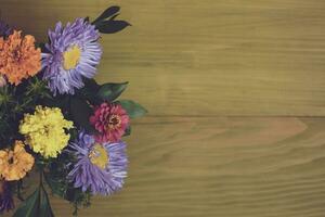 Image of beautiful flowers on wooden background. photo