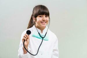 Beautiful little doctor holding stethoscope. photo