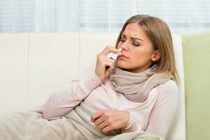 Woman using nasal spray photo