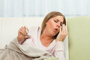 Woman having flu and coughing photo