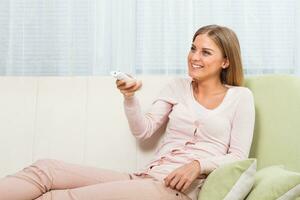 Beautiful woman  watching tv photo