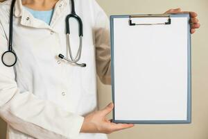 Image of female doctor showing clipboard. photo