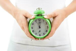 Woman holding clock photo