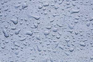 raindrops on the window in rainy days, abstract and blue background photo