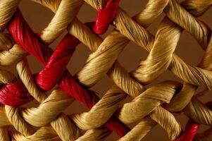 close up of a woven basket with red and gold thread photo