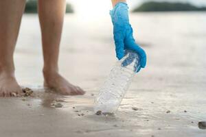 Save water. Volunteer pick up trash garbage at the beach and plastic bottles are difficult decompose prevent harm aquatic life. Earth, Environment, Greening planet, reduce global warming, Save world photo