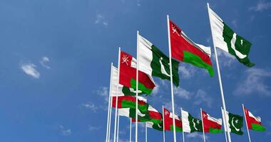 Pakistan and Oman Flags Waving Together in the Sky, Seamless Loop in Wind, Space on Left Side for Design or Information, 3D Rendering video