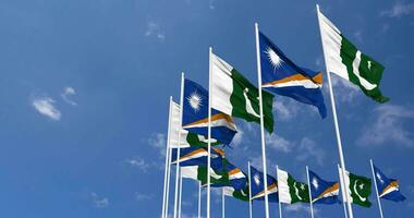 Pakistan and Marshall Islands Flags Waving Together in the Sky, Seamless Loop in Wind, Space on Left Side for Design or Information, 3D Rendering video