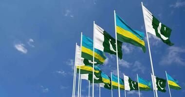 Pakistan and Rwanda Flags Waving Together in the Sky, Seamless Loop in Wind, Space on Left Side for Design or Information, 3D Rendering video