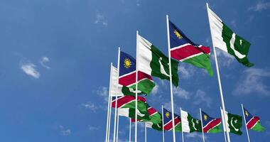 Pakistan and Namibia Flags Waving Together in the Sky, Seamless Loop in Wind, Space on Left Side for Design or Information, 3D Rendering video