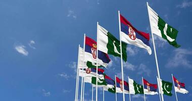 Pakistan and Serbia Flags Waving Together in the Sky, Seamless Loop in Wind, Space on Left Side for Design or Information, 3D Rendering video