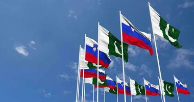 Pakistan and Slovenia Flags Waving Together in the Sky, Seamless Loop in Wind, Space on Left Side for Design or Information, 3D Rendering video