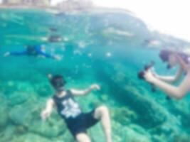 Blurred scene tourist diving in the sea photo