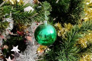 a green christmas ornament on a tree photo