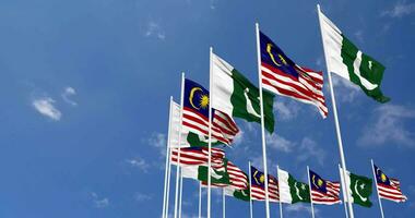 Pakistan and Malaysia Flags Waving Together in the Sky, Seamless Loop in Wind, Space on Left Side for Design or Information, 3D Rendering video