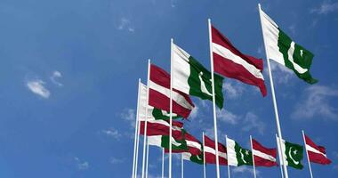 Pakistan and Latvia Flags Waving Together in the Sky, Seamless Loop in Wind, Space on Left Side for Design or Information, 3D Rendering video