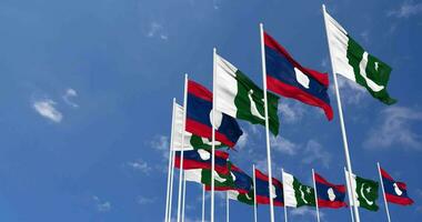 Pakistan and Laos Flags Waving Together in the Sky, Seamless Loop in Wind, Space on Left Side for Design or Information, 3D Rendering video