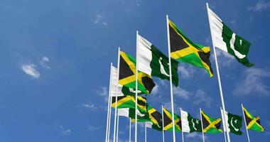 Pakistán y Jamaica banderas ondulación juntos en el cielo, sin costura lazo en viento, espacio en izquierda lado para diseño o información, 3d representación video