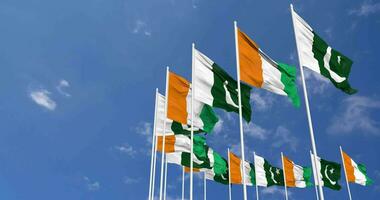 Pakistan and Ivory Coast Flags Waving Together in the Sky, Seamless Loop in Wind, Space on Left Side for Design or Information, 3D Rendering video