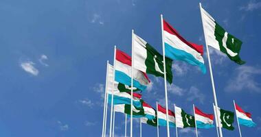 Pakistan and Luxembourg Flags Waving Together in the Sky, Seamless Loop in Wind, Space on Left Side for Design or Information, 3D Rendering video