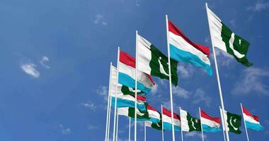 Pakistan and Luxembourg Flags Waving Together in the Sky, Seamless Loop in Wind, Space on Left Side for Design or Information, 3D Rendering video