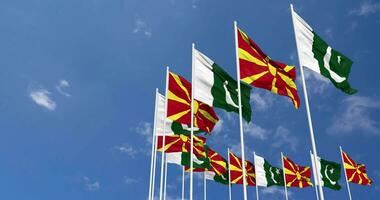 Pakistan and North Macedonia Flags Waving Together in the Sky, Seamless Loop in Wind, Space on Left Side for Design or Information, 3D Rendering video