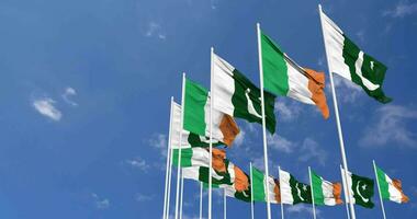 Pakistan and Ireland Flags Waving Together in the Sky, Seamless Loop in Wind, Space on Left Side for Design or Information, 3D Rendering video