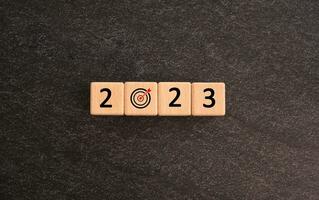 Start Goal in the new year 2023. number 2023 on wooden cubes. good year 2023 with goal plan, goal concept, action plan, strategy, business vision. Business development strategy, advancement photo