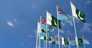 Pakistan and Fiji Flags Waving Together in the Sky, Seamless Loop in Wind, Space on Left Side for Design or Information, 3D Rendering video