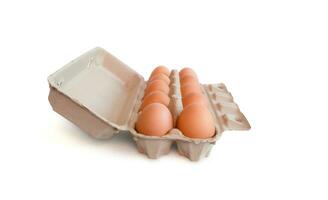 Open box with fresh brown eggs isolated on white background, clipping path. Fresh organic chicken eggs in carton box. photo