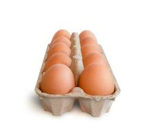 egg tray with fresh brown eggs isolated on white background, clipping path. Fresh organic chicken eggs in carton box. photo