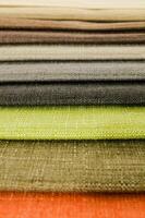 a stack of different colored fabric photo