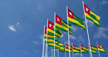 Togo Flags Waving in the Sky, Seamless Loop in Wind, Space on Left Side for Design or Information, 3D Rendering video