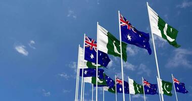 pakistan och Australien flaggor vinka tillsammans i de himmel, sömlös slinga i vind, Plats på vänster sida för design eller information, 3d tolkning video