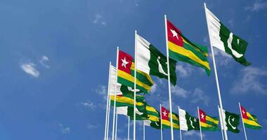 Pakistan and Togo Flags Waving Together in the Sky, Seamless Loop in Wind, Space on Left Side for Design or Information, 3D Rendering video