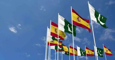 Pakistan and Spain Flags Waving Together in the Sky, Seamless Loop in Wind, Space on Left Side for Design or Information, 3D Rendering video