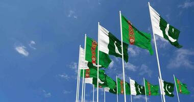 pakistan och turkmenistan flaggor vinka tillsammans i de himmel, sömlös slinga i vind, Plats på vänster sida för design eller information, 3d tolkning video