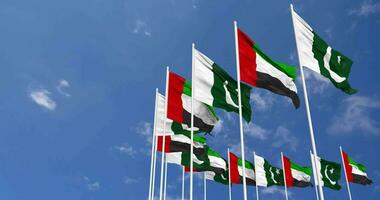 Pakistan and United Arab Emirates Flags Waving Together in the Sky, Seamless Loop in Wind, Space on Left Side for Design or Information, 3D Rendering video