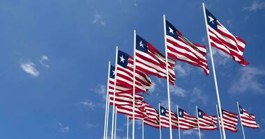 Liberia Flags Waving in the Sky, Seamless Loop in Wind, Space on Left Side for Design or Information, 3D Rendering video