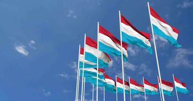 Luxembourg Flags Waving in the Sky, Seamless Loop in Wind, Space on Left Side for Design or Information, 3D Rendering video