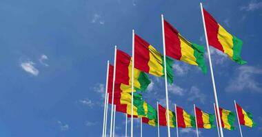 Guinea Flags Waving in the Sky, Seamless Loop in Wind, Space on Left Side for Design or Information, 3D Rendering video