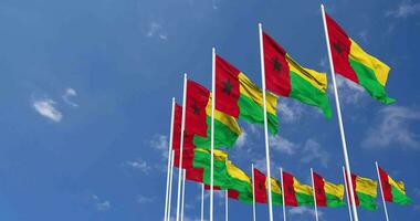 Guinea Bissau Flags Waving in the Sky, Seamless Loop in Wind, Space on Left Side for Design or Information, 3D Rendering video