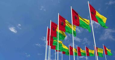 Guinea Bissau Flags Waving in the Sky, Seamless Loop in Wind, Space on Left Side for Design or Information, 3D Rendering video