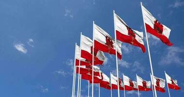 Gibraltar Flags Waving in the Sky, Seamless Loop in Wind, Space on Left Side for Design or Information, 3D Rendering video