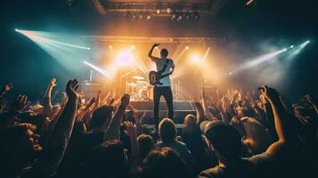 AI generated live band playing on stage in a dimly lit nightclub, with a sea of enthusiastic fans jumping photo